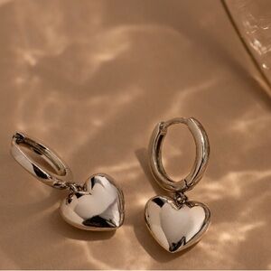 Dangle sterling silver heart earrings .